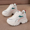 Women's white beige height increasing dad shoes with mesh upper and cross straps.