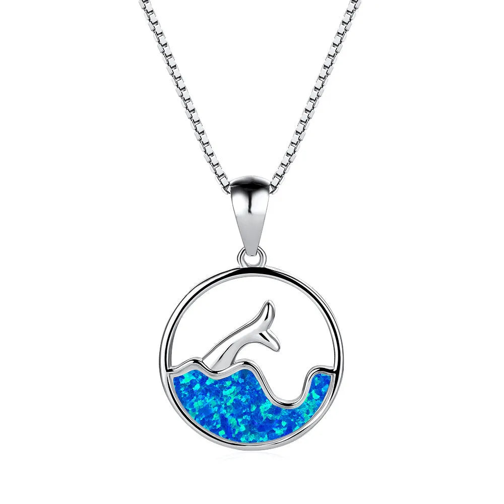 White gold geometric sea fishtail pendant necklace with a round blue opal stone on a chain.