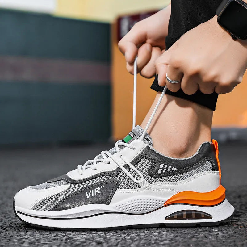 Men's grey mesh running shoes with round toe and middle top design on light background