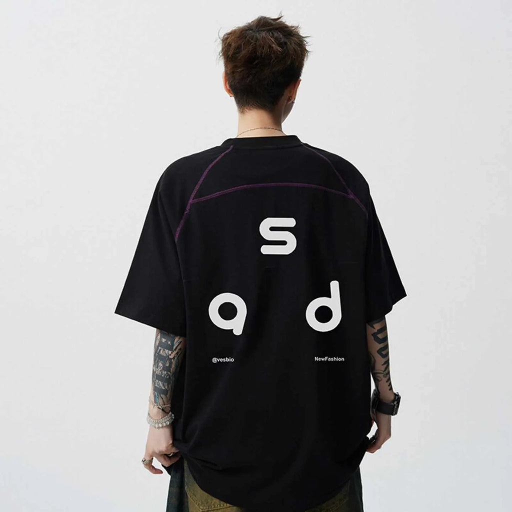 Loose fit black cotton t-shirt with letter print graphic on front, short sleeves, and round neck.