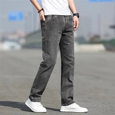 Man wearing smoky grey straight leg jeans with low waist and zipper fly.