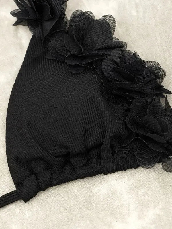 Black gathered style polyester swimwear set with a top and shorts on a mannequin