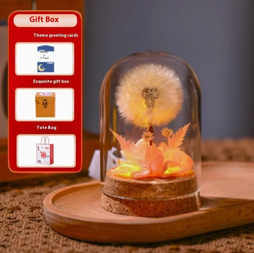 Dandelion-shaped glass night light ornament in gradient colours on wooden surface