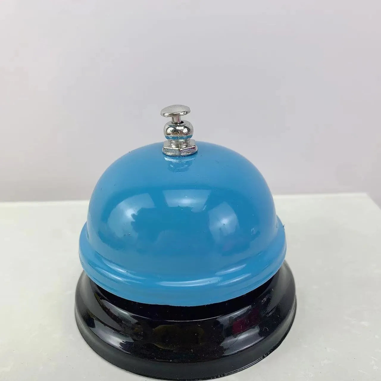 Iron game bell shown in one of ten available colours: blue, green, pink, red, yellow, green tea, or rose kiss.