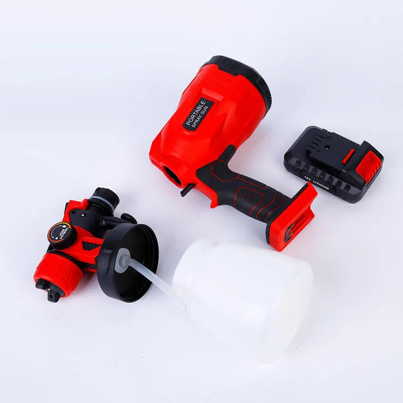 Blue cordless automatic paint spray gun with 800ml can and 1.8mm nozzle on a workbench.