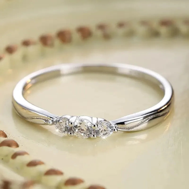 S925 sterling silver ripple wave ring with white gold electroplated finish on white background