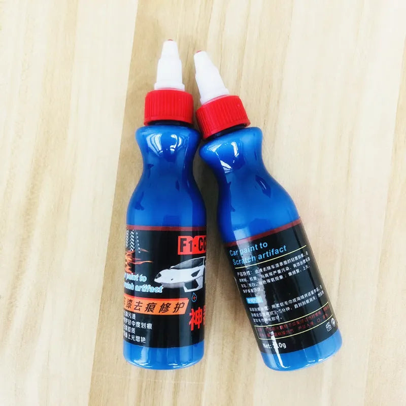 Small blue car scratch repair agent bottle with application tool for automobile bodywork