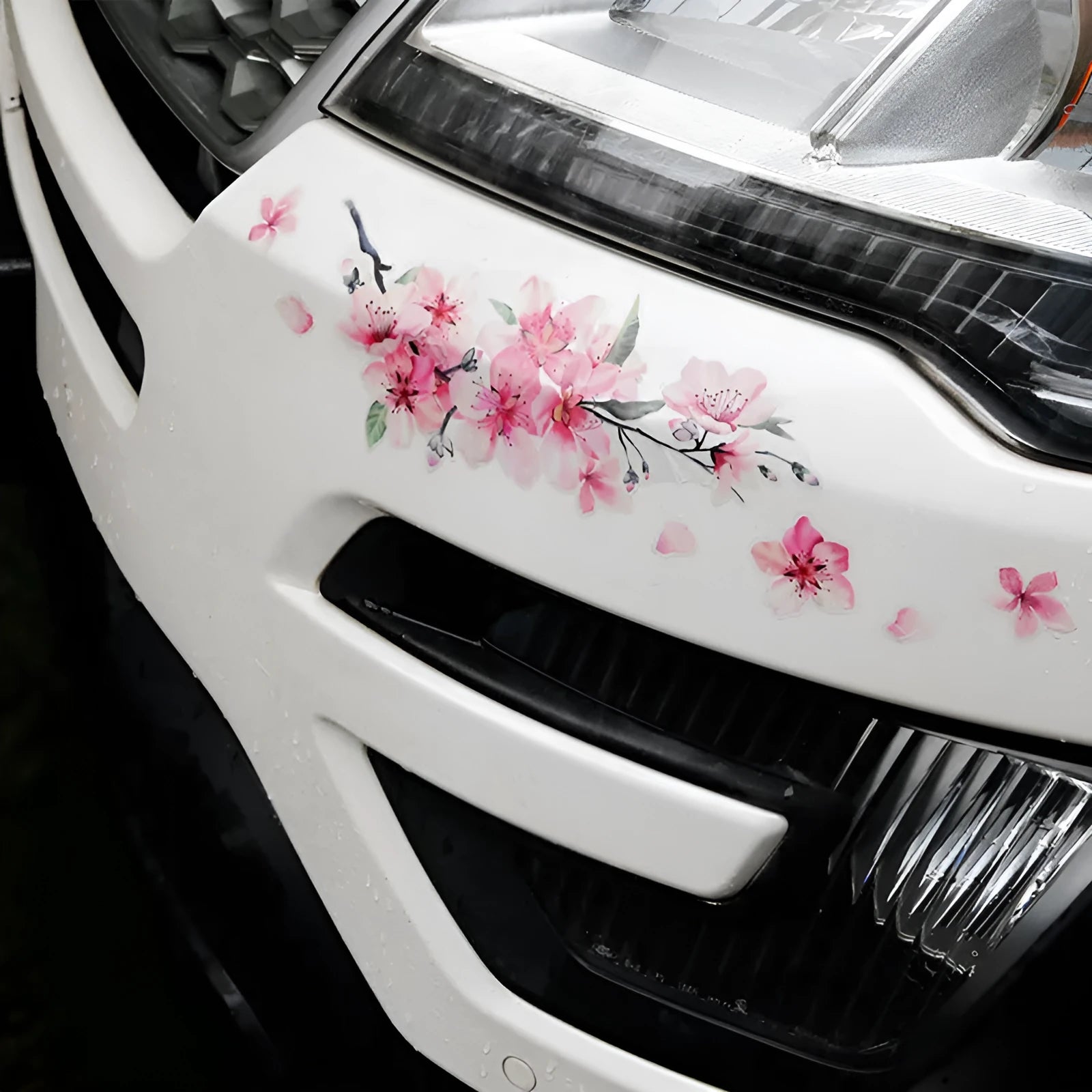 Close-up of a cherry blossom flower pattern on a PVC car sticker, shown with a peel-off backing.