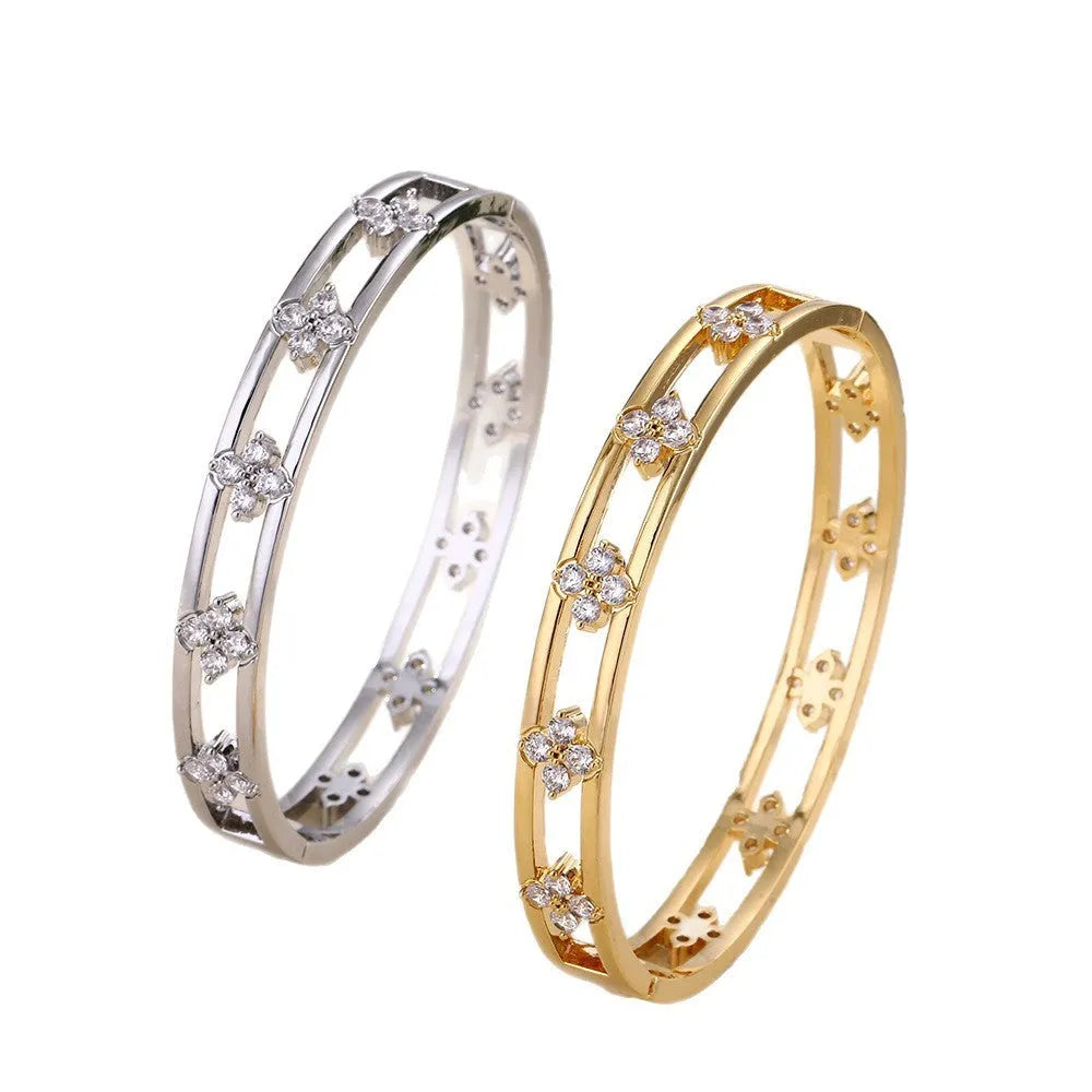 Women's simple hollow bracelet with four-leaf clover charm in gold or silver finish