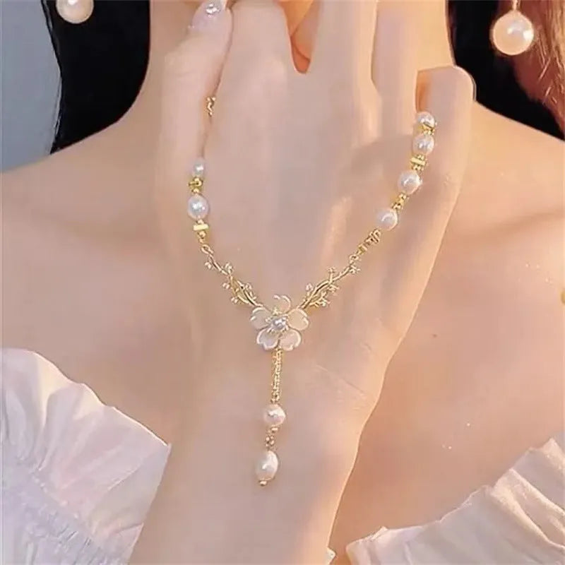 Alloy necklace with pearl flower pendant and floral design elements