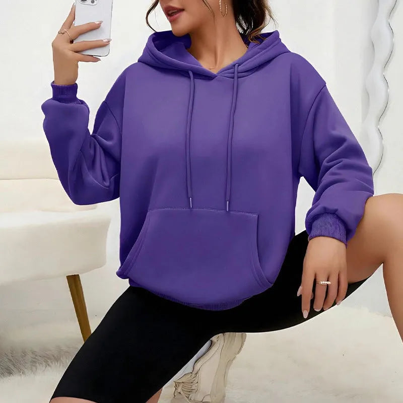 Women's loose grey drawstring hood sweatshirt with a front kangaroo pocket on a hanger.