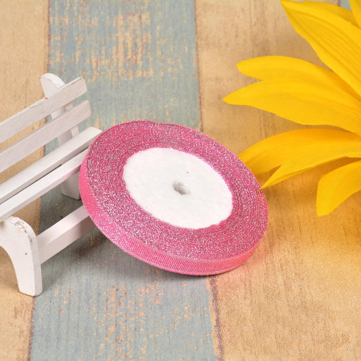A roll of colourful green onion pattern polyester ribbon with metallic wire highlights, shown at 3-points width.
