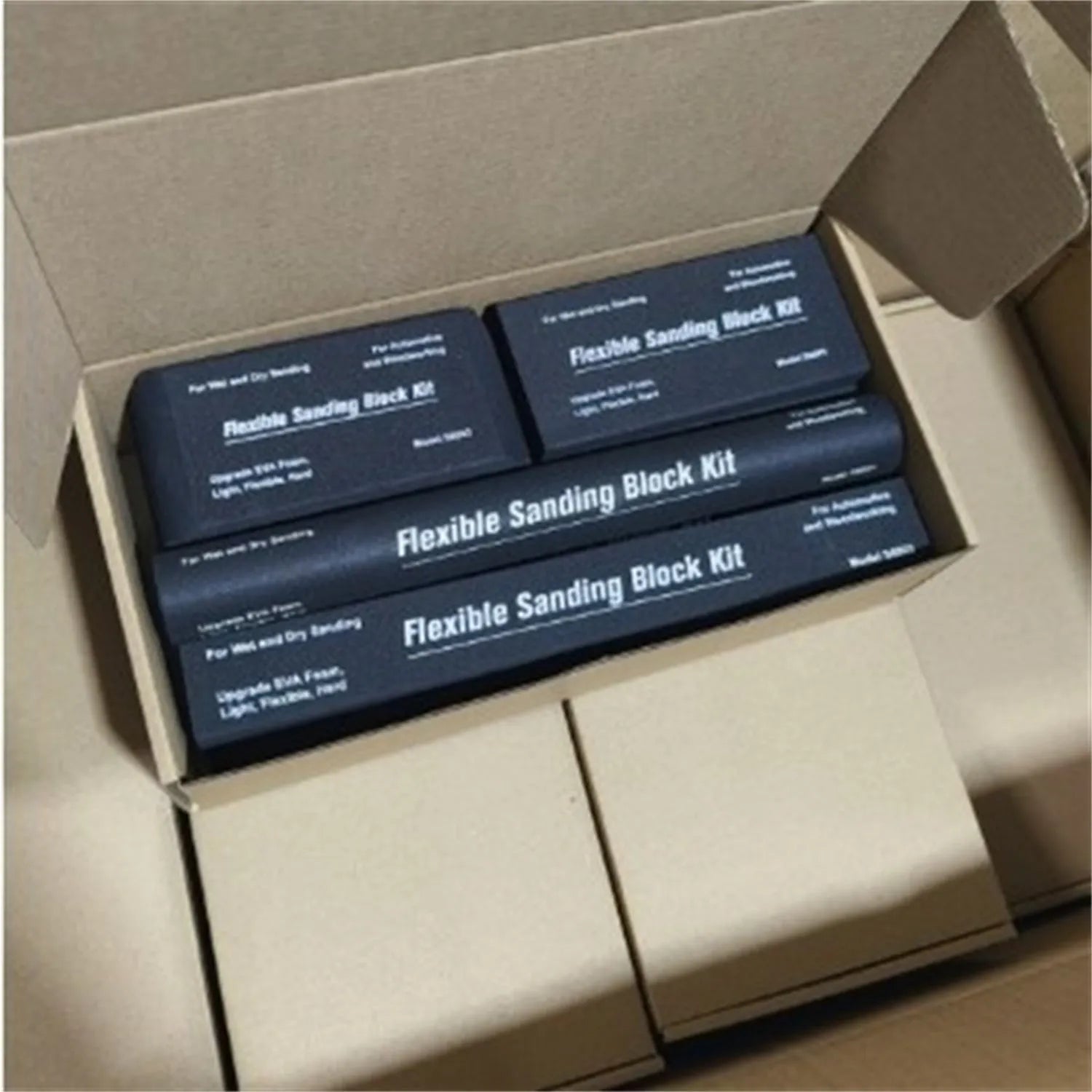 Seven black EVA frosted metal blocks arranged as a set