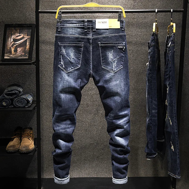 Men's slim-fit skinny jeans in dark blue denim on a neutral background.