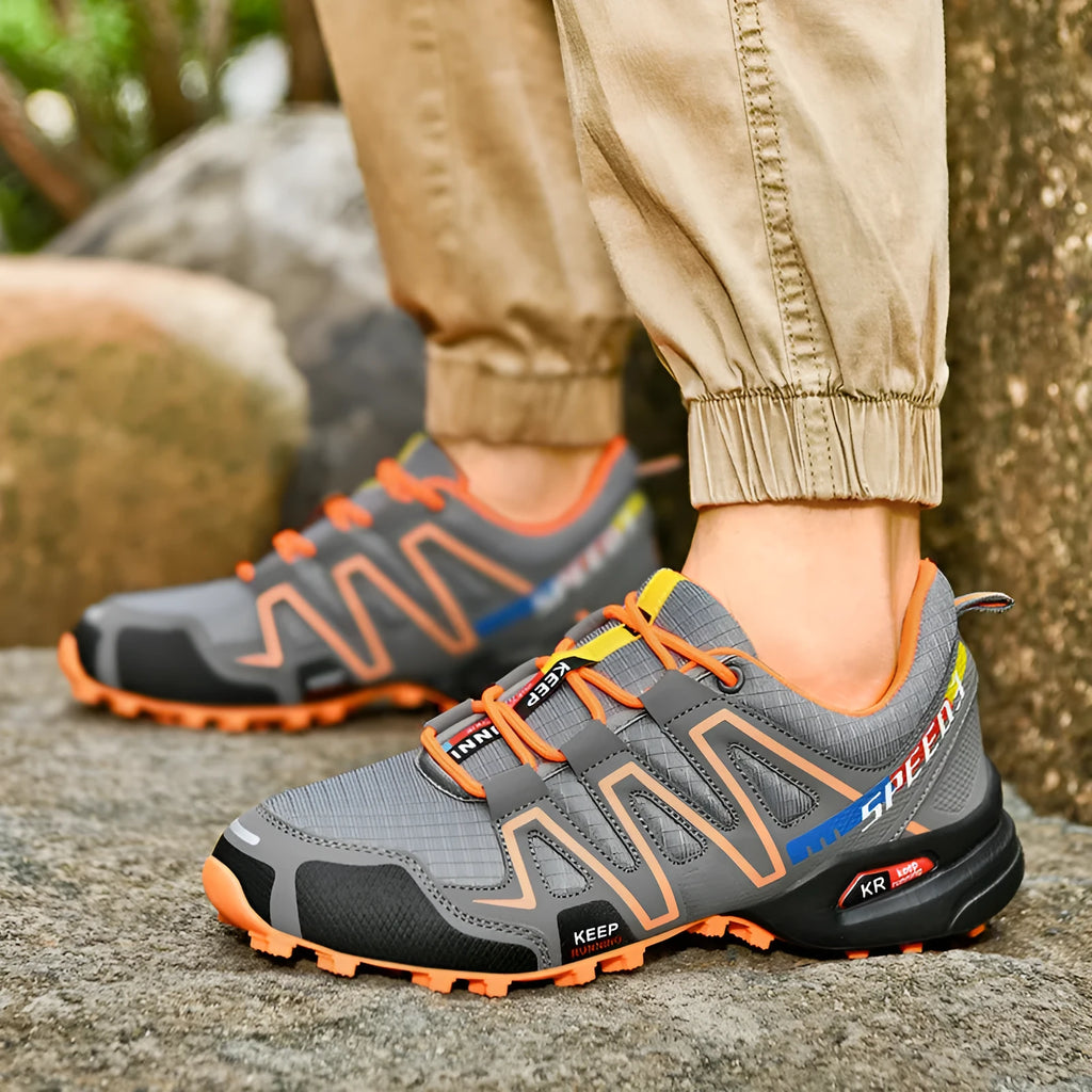 Men's low-top casual shoes in grey-orange, synthetic leather upper with mesh lining, on a rubber sole.