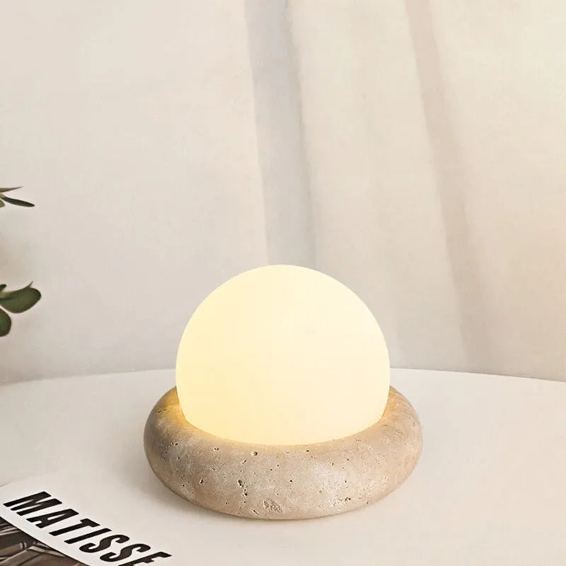 Cream style bedside night light with remote control on bedroom surface
