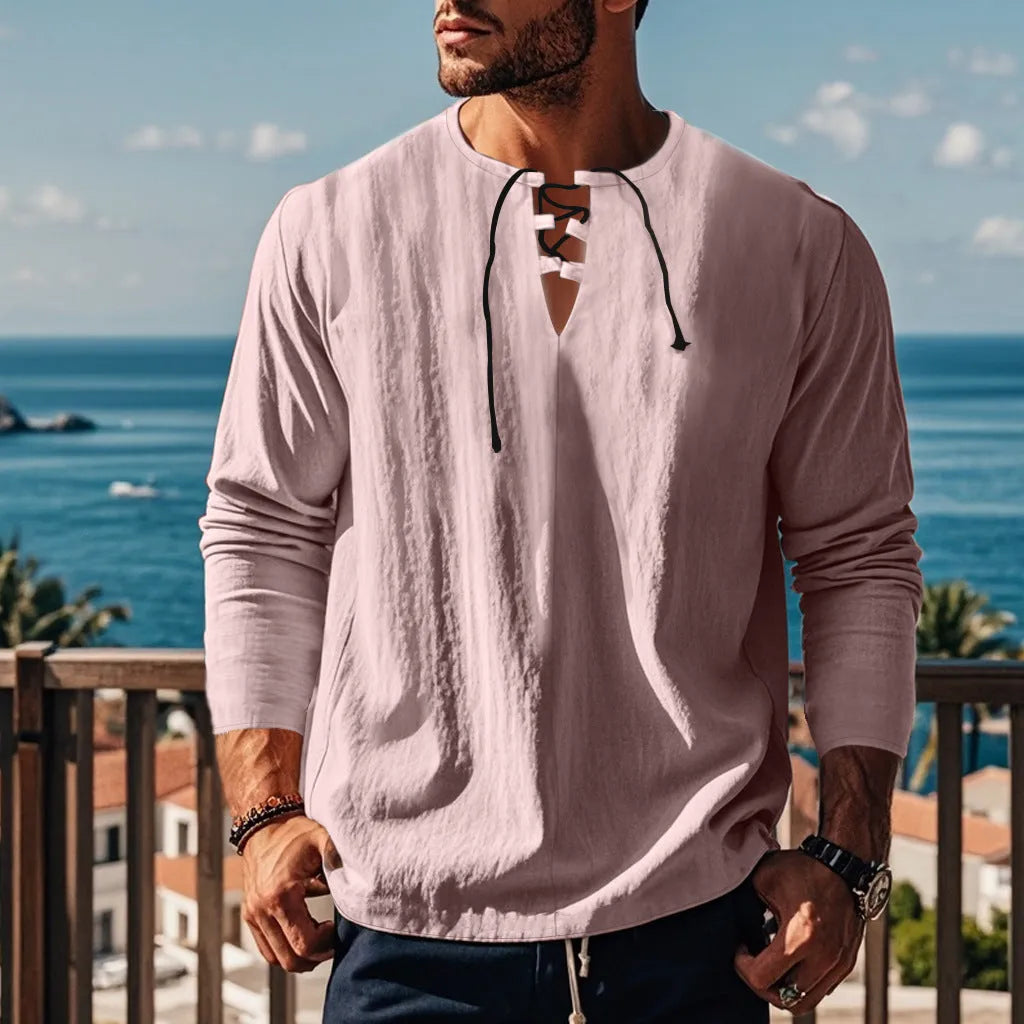 Cotton linen blend solid colour beach shirt in a loose pullover style on a hanger.