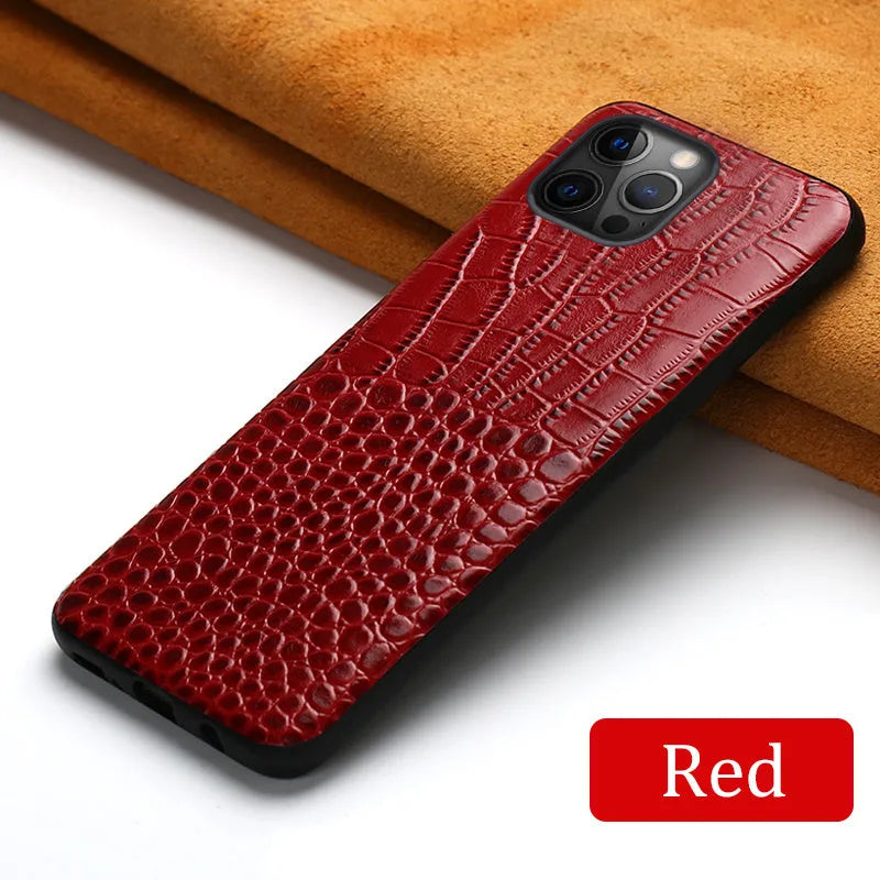 Handmade black leather iPhone case with a crocodile pattern texture on a table.