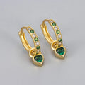 Women's heart-shaped drop earrings with coloured zircon or corundum stone in gold or white gold tone.