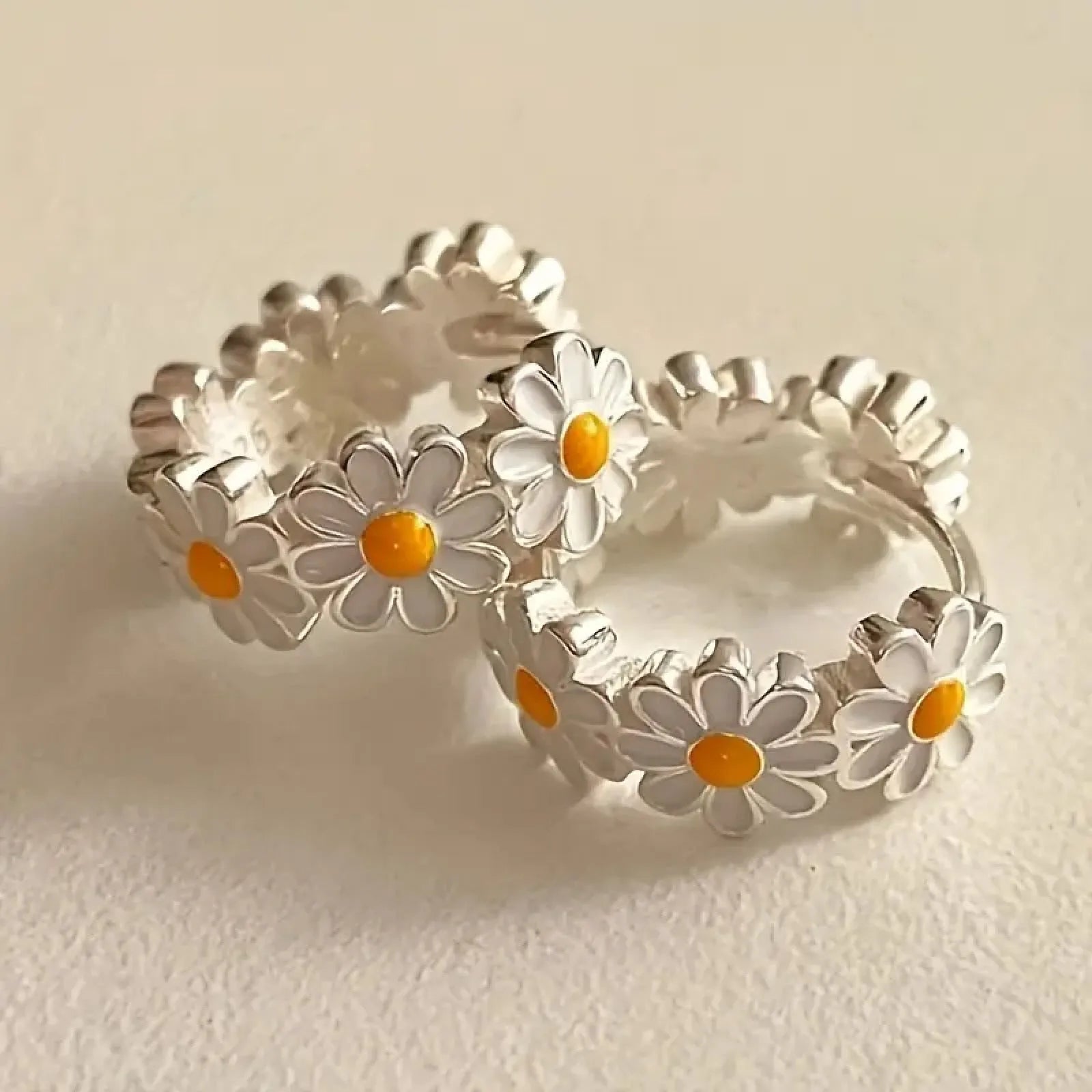 White daisy flower ring earrings with platinum gemstone accents on copper base