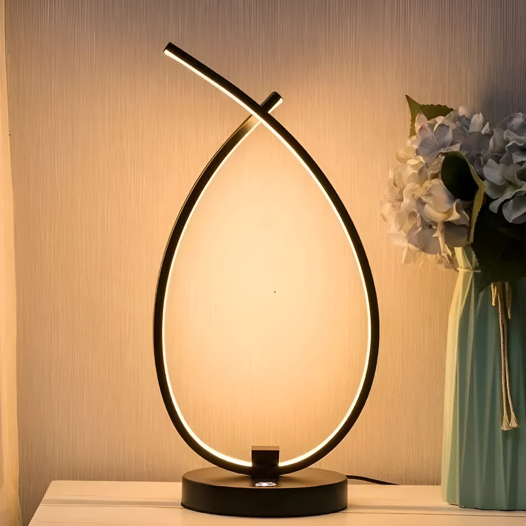 Black water drop shaped USB table lamp with touch control on wooden bedside table