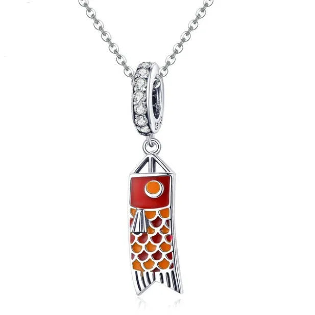S925 sterling silver carp streamer pendant necklace with zircon detailing on a dark background.