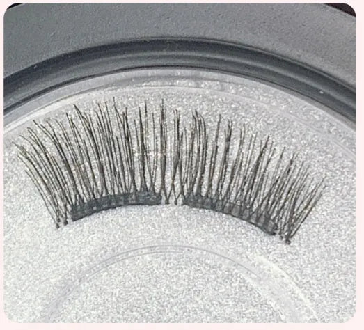 Magnetic false eyelash set with soft and hard lashes and curler on white background