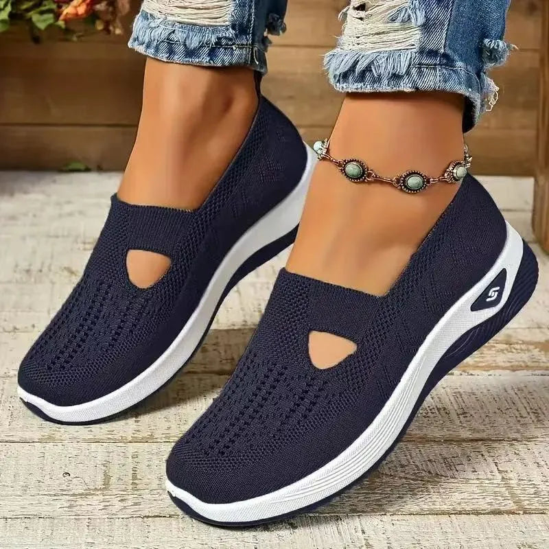 Women's low-top mesh casual flats with a T-strap in various colours on a soft PVC sole.
