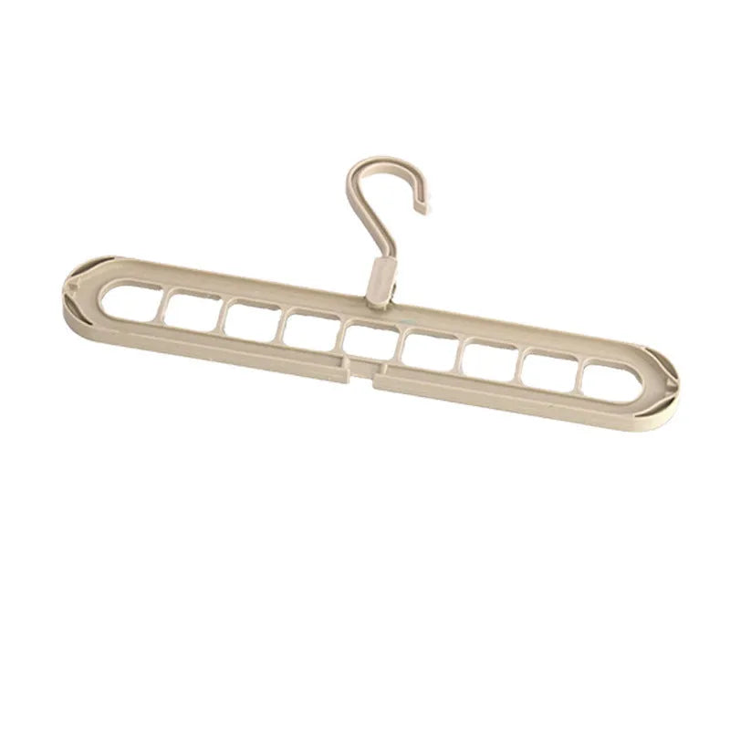 Plastic nine-hole hanger for folding trousers in beige, blue, green, grey, or pink.