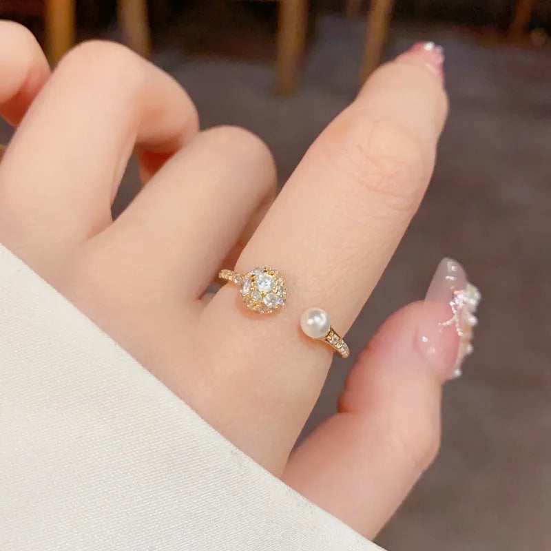 Gold or silver open-end women's ring with round zircon stones on a geometric copper band.