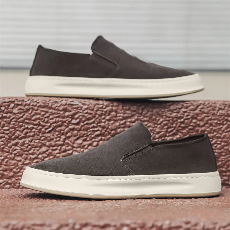 Men's casual slip-on shoes in apricot colour with round toe and mid heel, showing sewing line detail on artificial PU upper