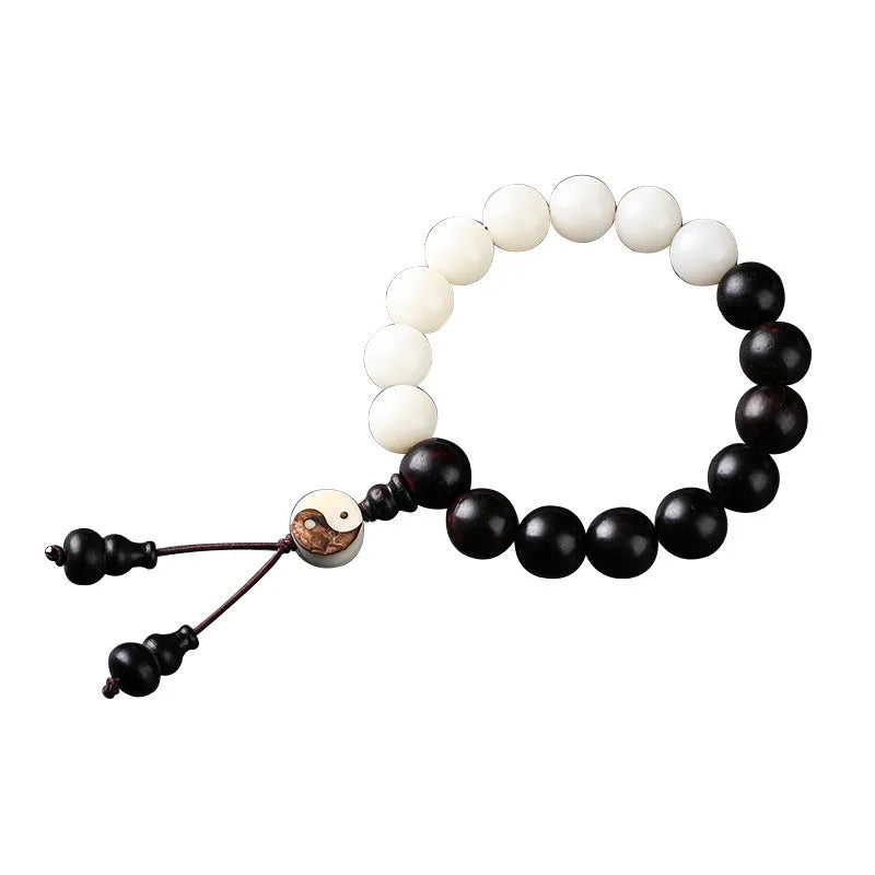 Close-up of a white retro eight-diagram-shaped Bodhi bead bracelet with 11mm beads on a black background.