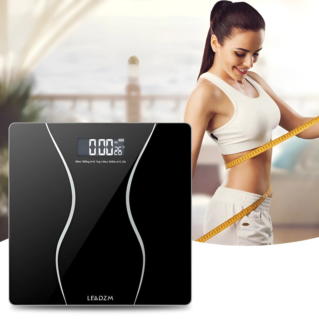 Black electronic bathroom scale on a flat surface showing digital display.
