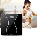 Black electronic bathroom scale on a flat surface showing digital display.