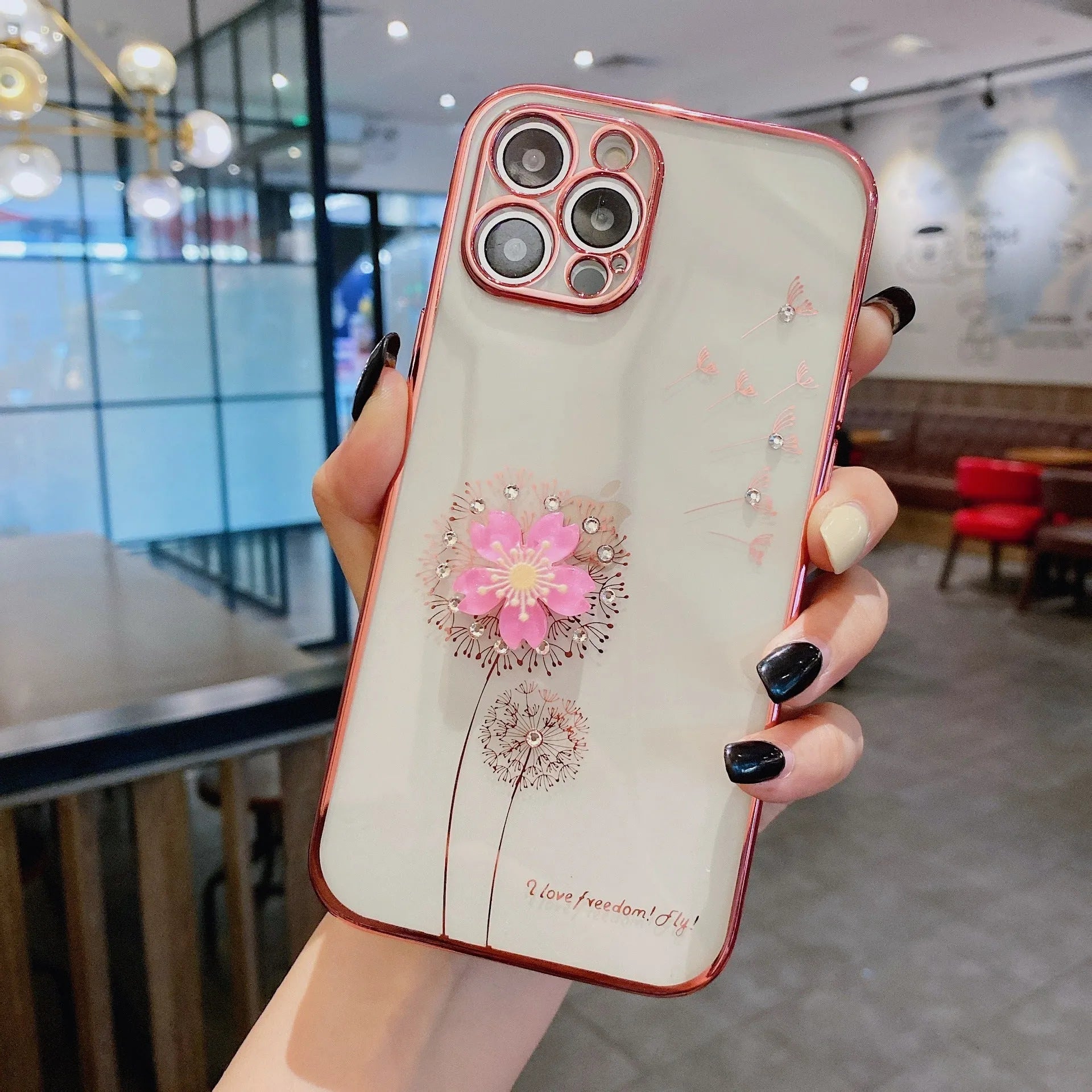 Green 3D flower spin stand phone case for iPhone on a table, showing built-in screen protector and stand.