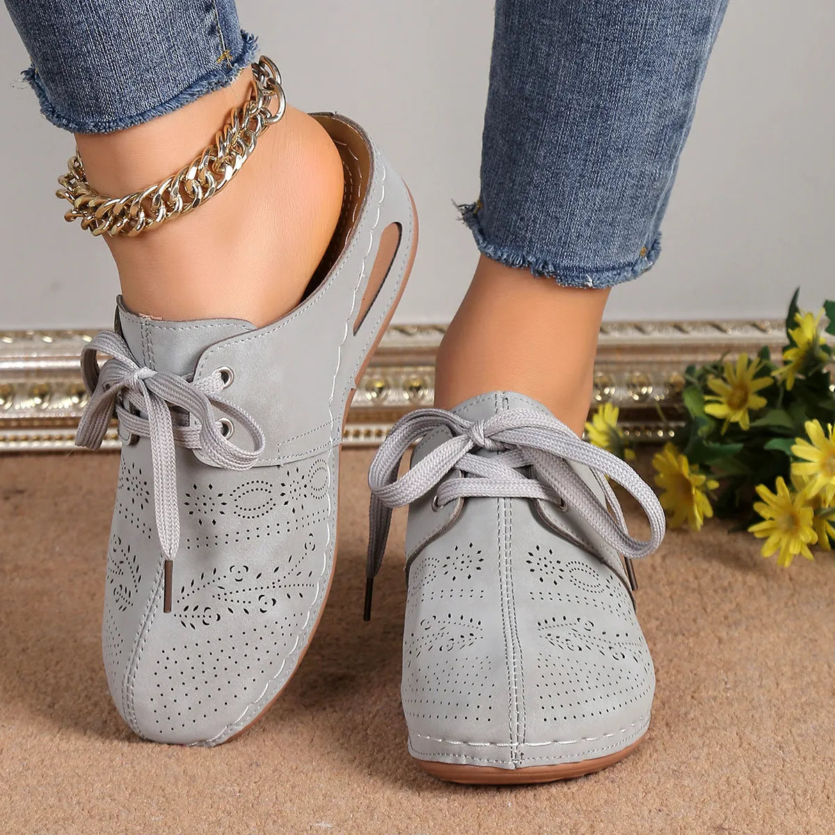 Women's black lace-up wedge slippers with a suede upper and rubber sole on a white background.