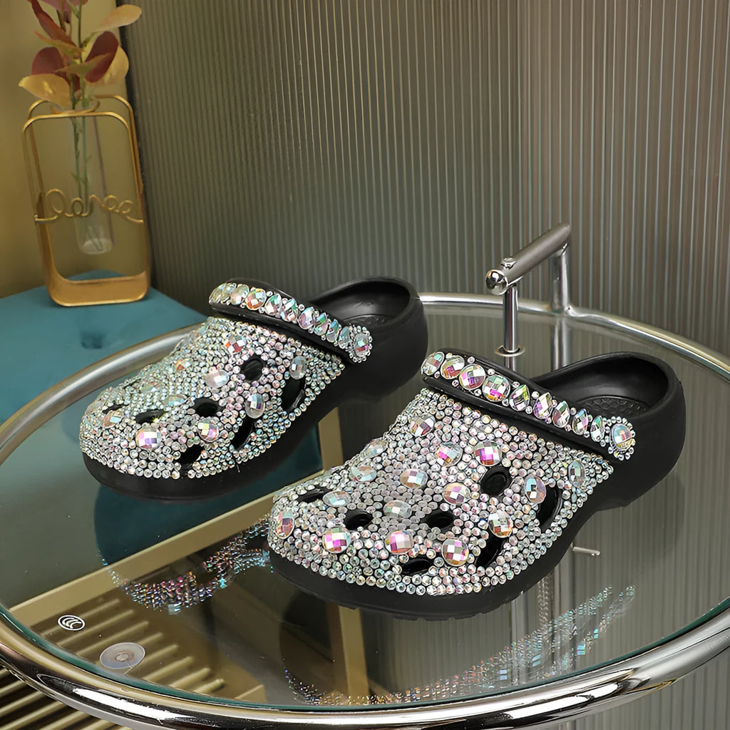 Black women's platform sandals with rhinestone detail and an open hole design on the EVA upper.