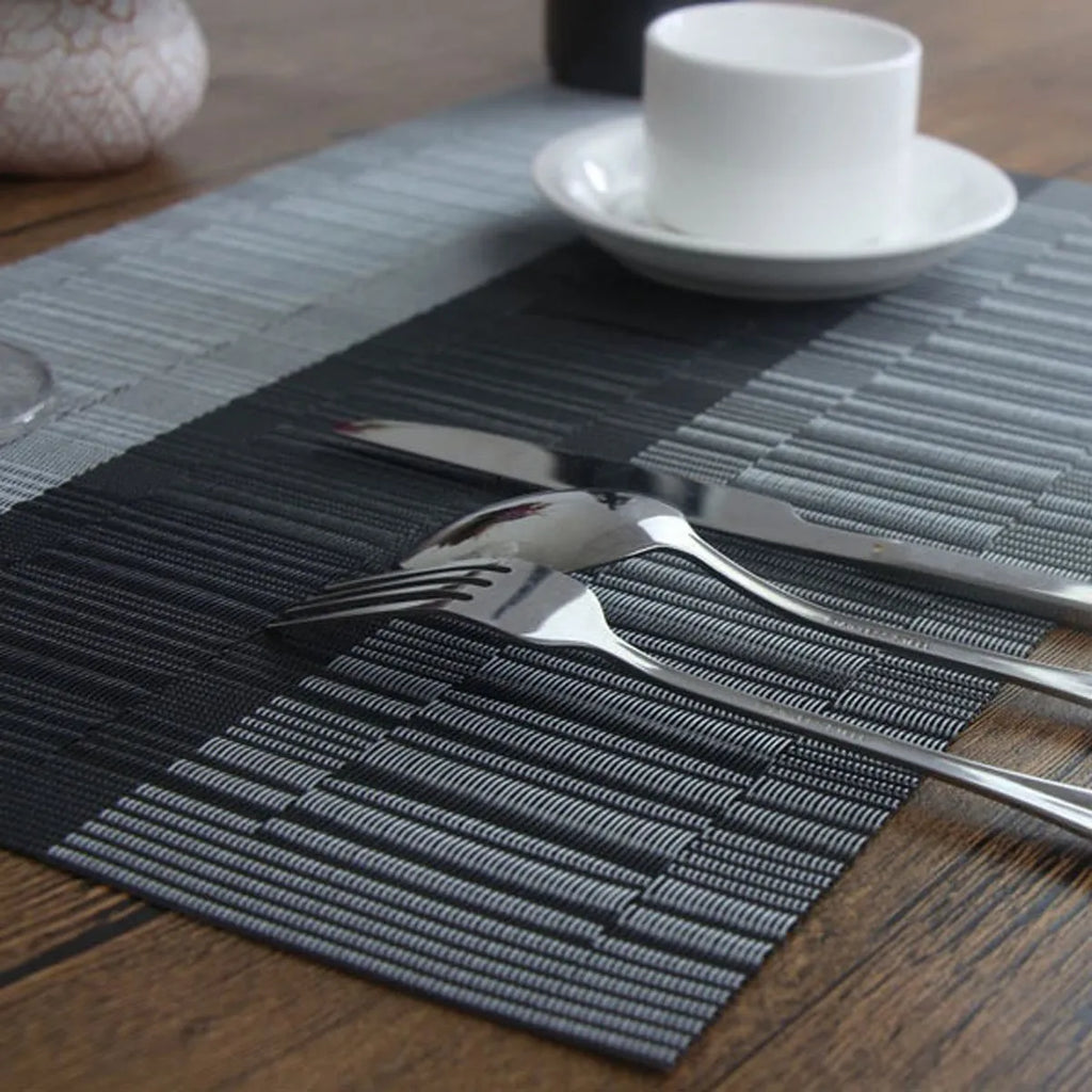 Modern simple PVC place mat in gradient bamboo pattern on a wooden table.