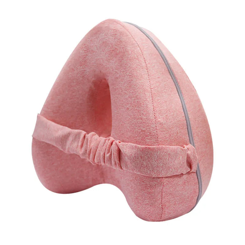 Heart-shaped dark blue jacquard memory foam leg pillow for adults on a bed.