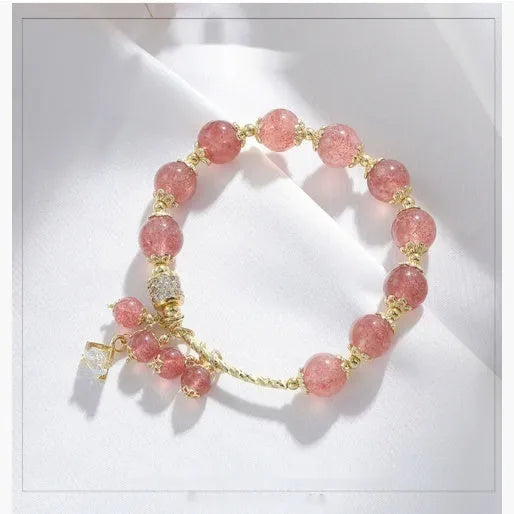 Pink strawberry quartz crystal heart-shaped women's bracelet with pearl accents.