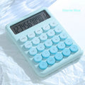 A gradient colour desk calculator on a desk, showing violet, mint green, blue, and pink colour options.