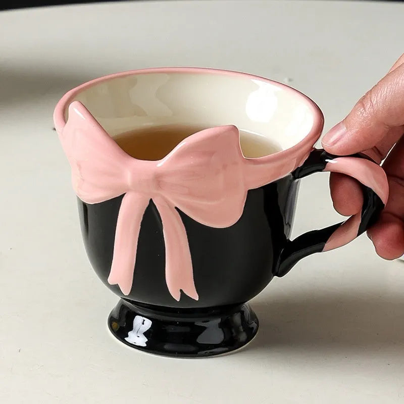 Ceramic mug with a cute girl heart bow design in black pink and white powder colours.