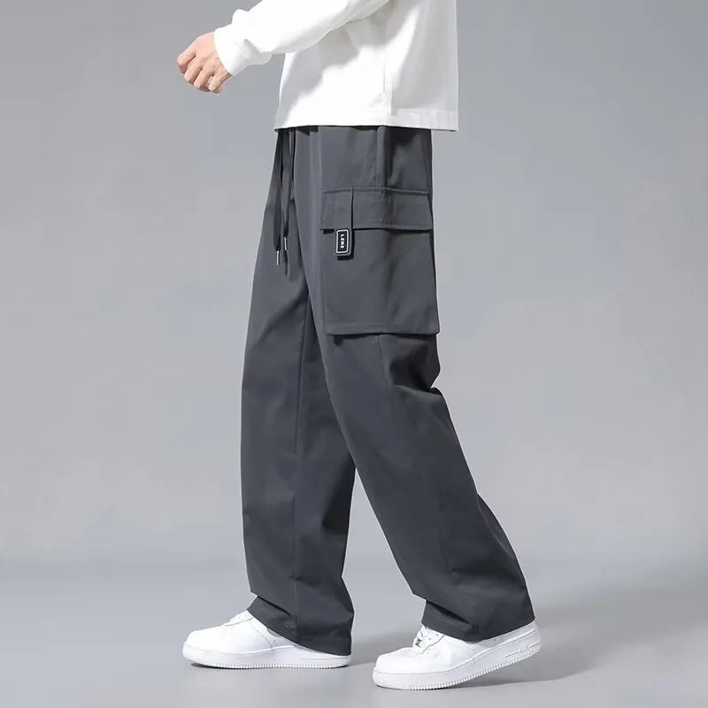 Boys straight leg cargo pants in army green with large pockets and a drawstring waist.