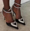 Women's black satin sandals with heart rhinestone detail and pointed toe, showing winding tape wearing method