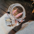 Three-dimensional butterfly USB cable protection sleeve in butterfly colour with silver foil finish on a white background