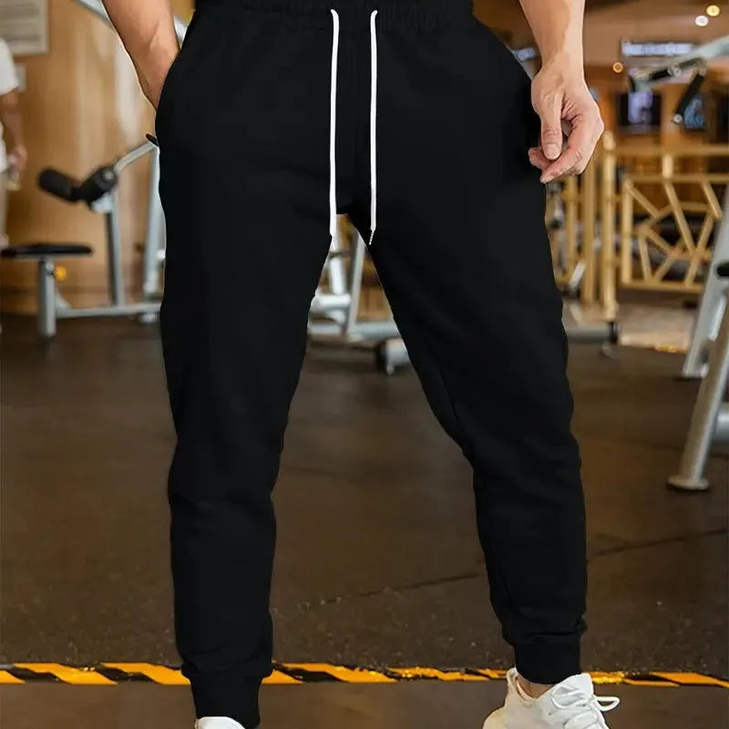 Men's loose-fit linen-style casual trousers with an elastic drawstring waist, shown in a neutral colour.