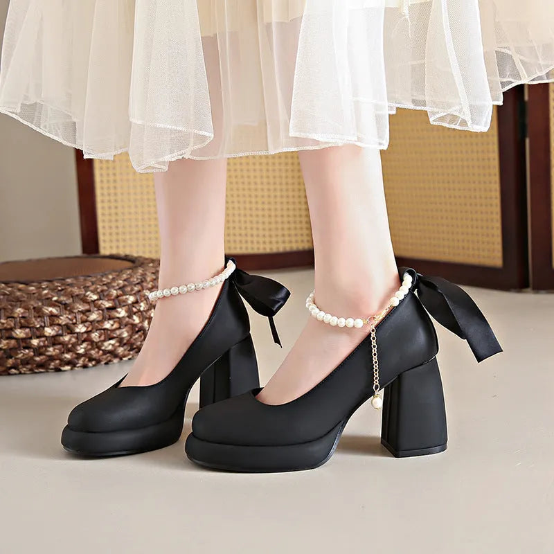 Women's beige Mary Jane shoes with chunky heel and ankle strap buckle showing round toe design