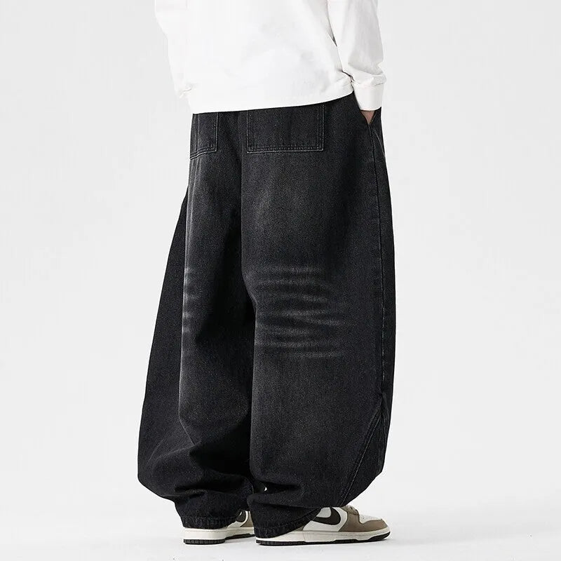 Man wearing plus size light blue wide leg baggy jeans, low waist straight leg casual style.