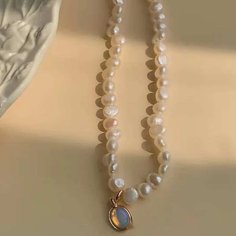 Adjustable French vintage style pearl necklace with geometric links on a white background.