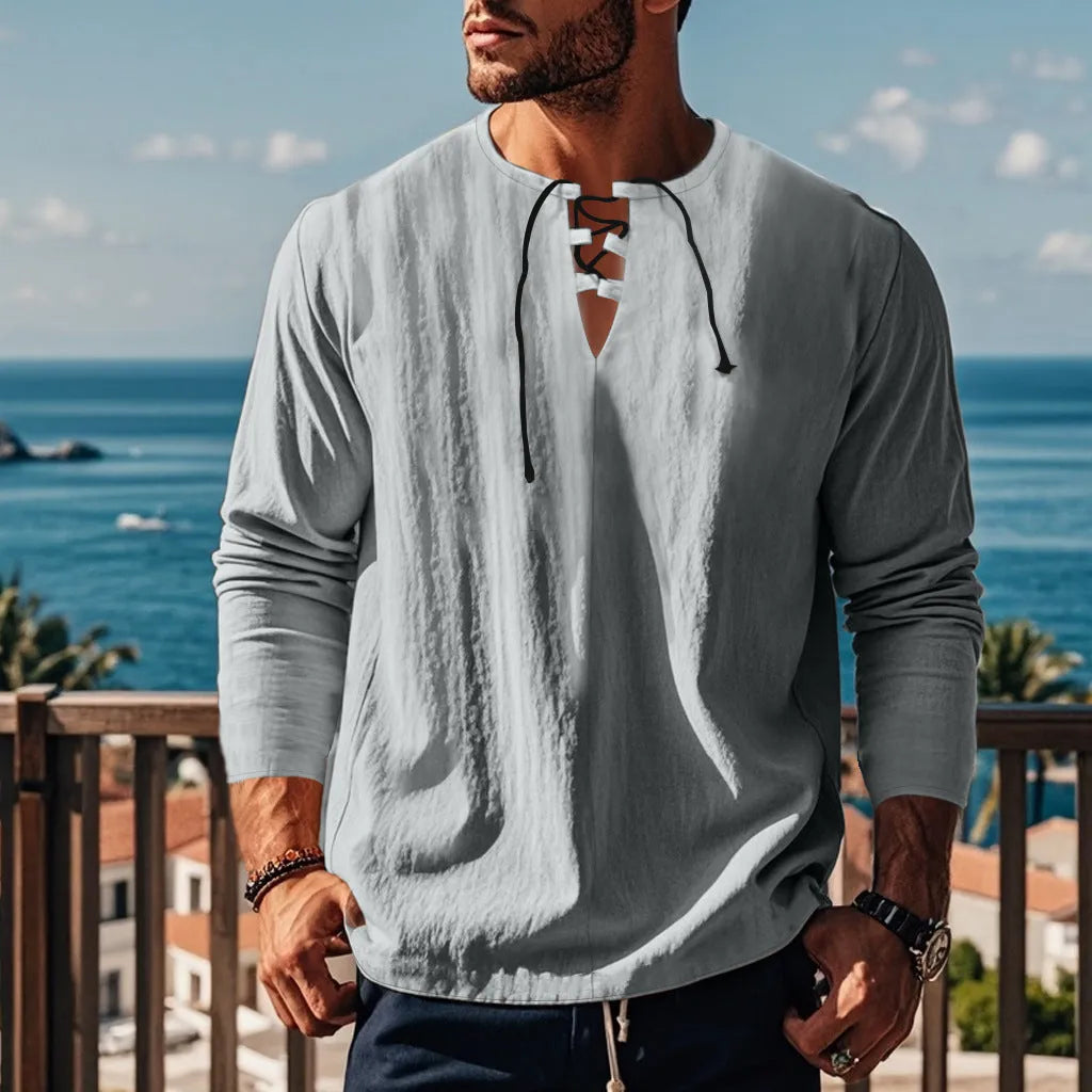 Cotton linen blend solid colour beach shirt in a loose pullover style on a hanger.